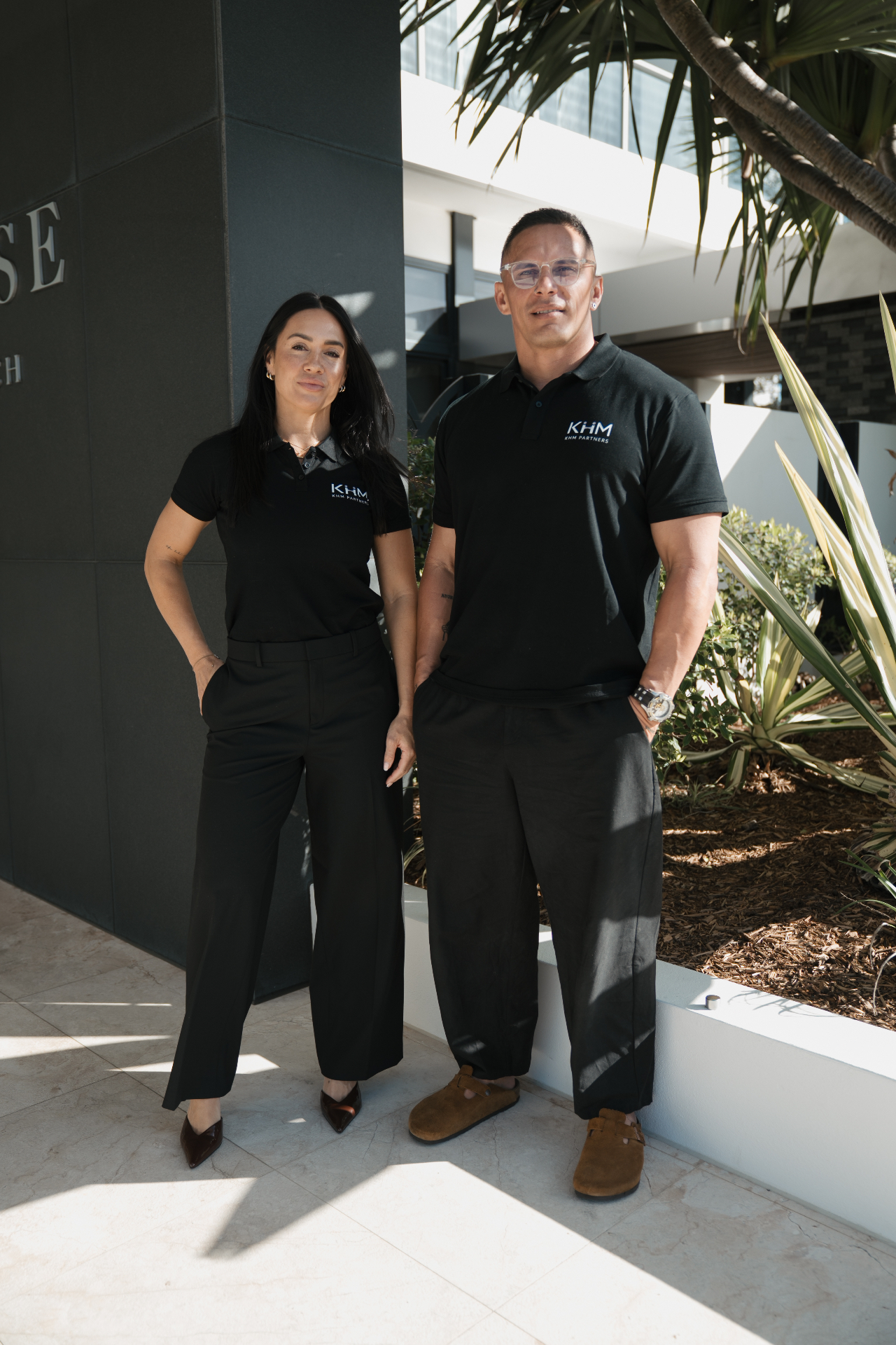 Watene Waenga and Erin Fale standing together outdoors in KHM Partners polos